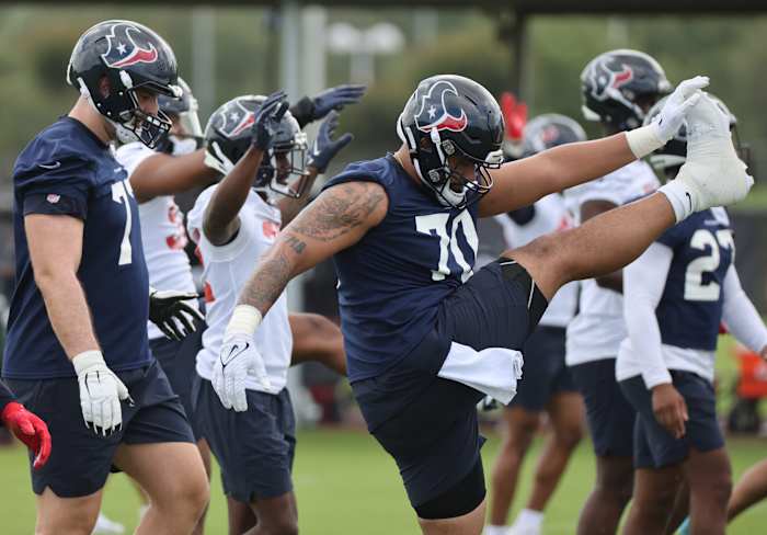 Texans outside linebacker Juice Scruggs (70) stretches during rookie camp at the Methodist practice facility.